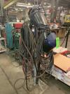 Lot Comprising Rack of Assorted Welding Leads and Guns w/ Torch and Welding Helmets (Plant Location: Blacksmith Shop)